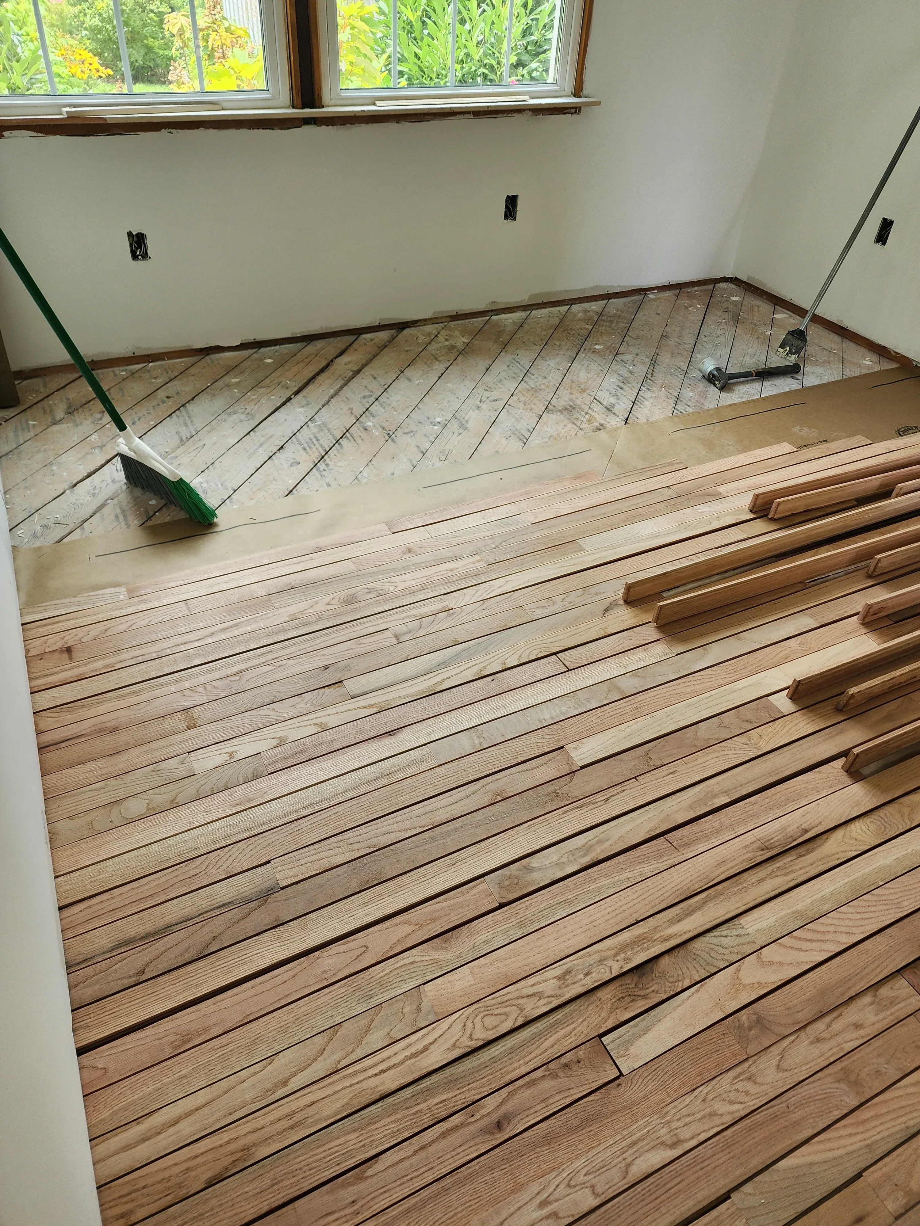 Diagonal wood plank ceiling installation on vaulted surface with exposed beam details